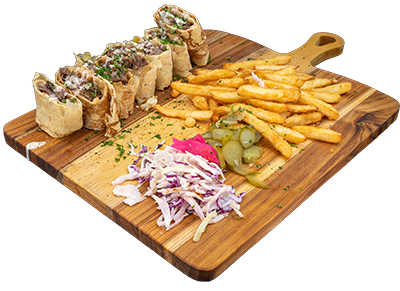 Arabic style shawarma wrap filled with juicy marinated chicken, crispy fries, fresh salad, and creamy garlic sauce in warm pita or tortilla